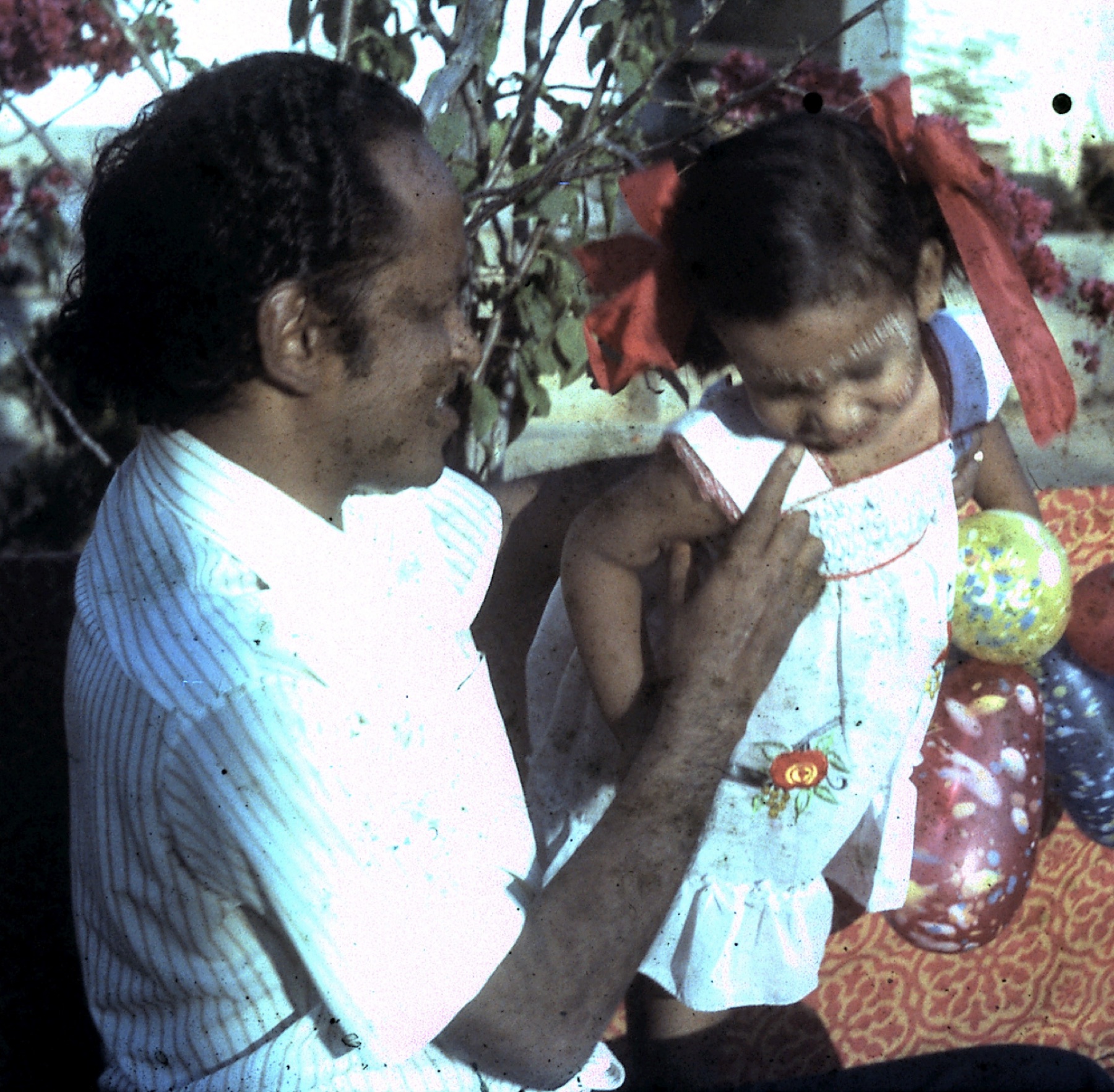 Dr. Das playing with his young daughter